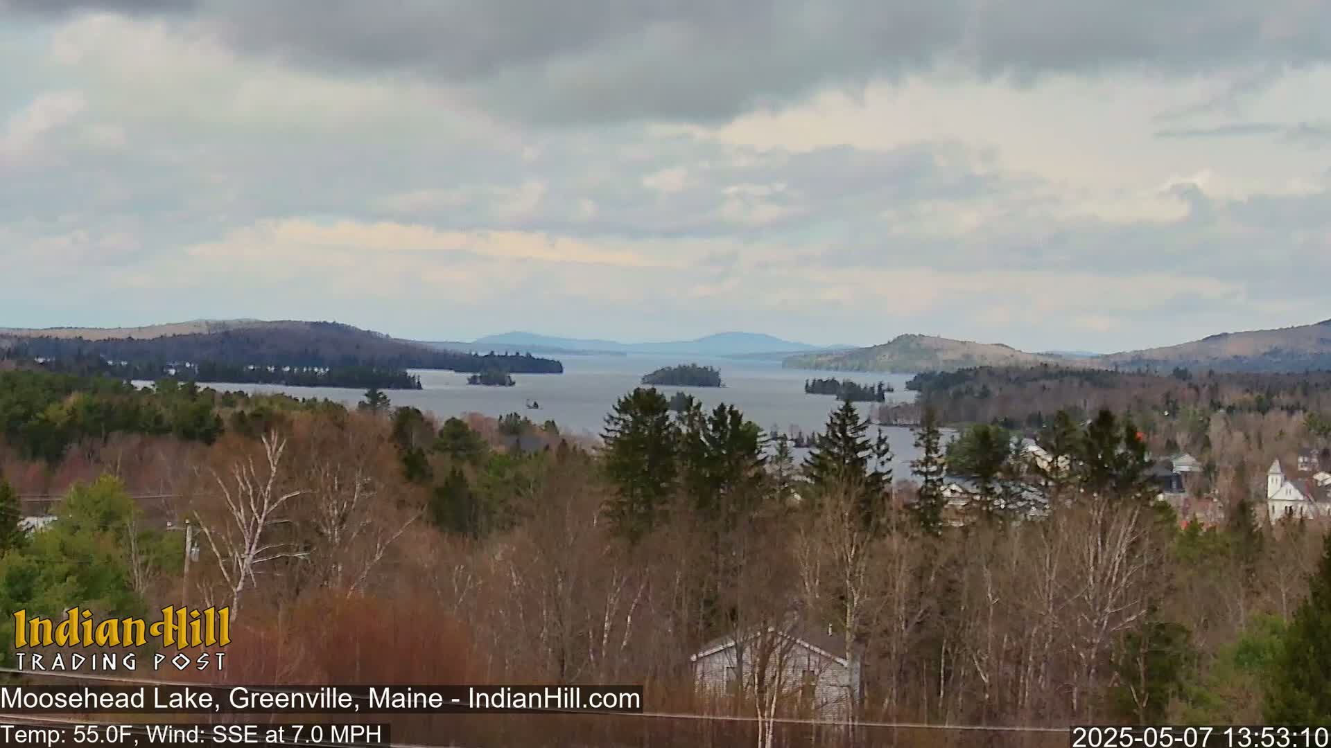 A view of Moosehead Lake from a wooded hillside on an overcast day with a 7 mph wind from the south-southeast.