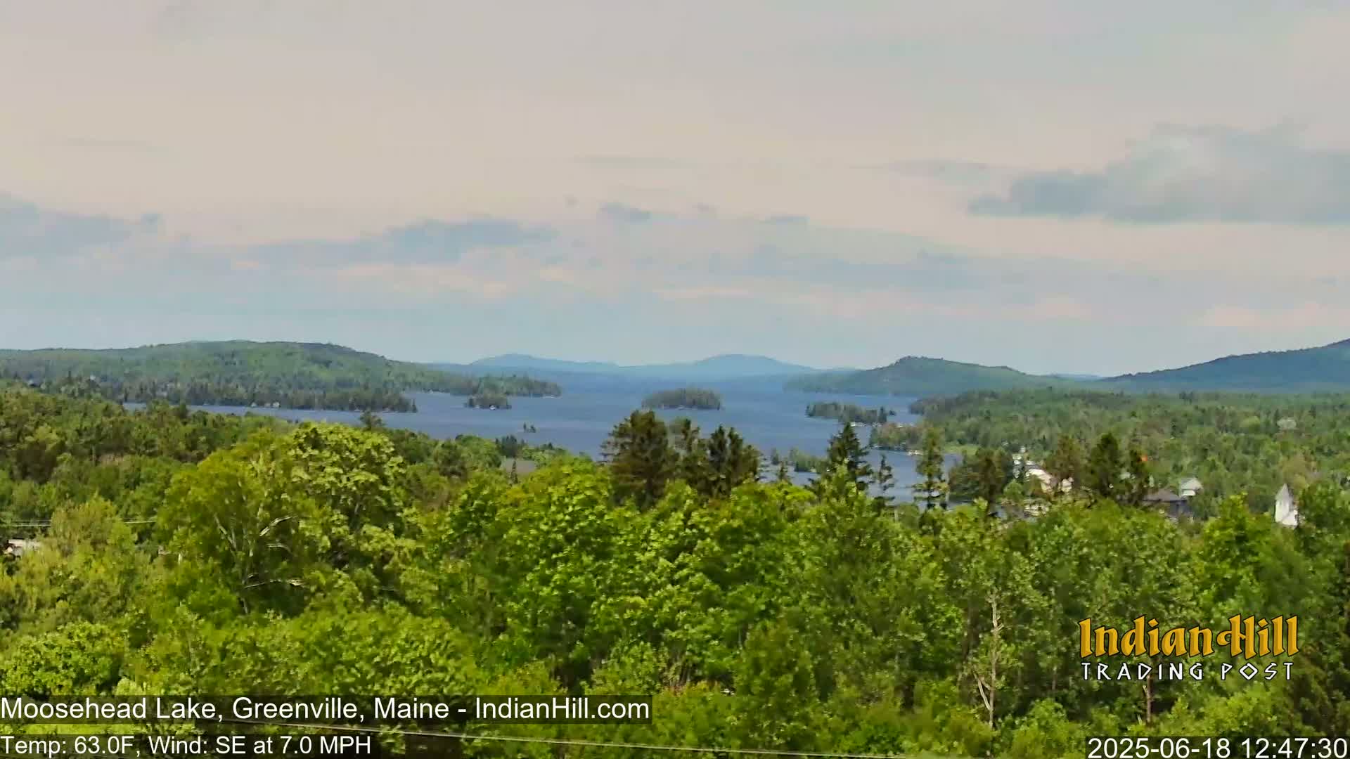 A view of Moosehead Lake from a wooded hillside on a partly cloudy day with a southeasterly wind.