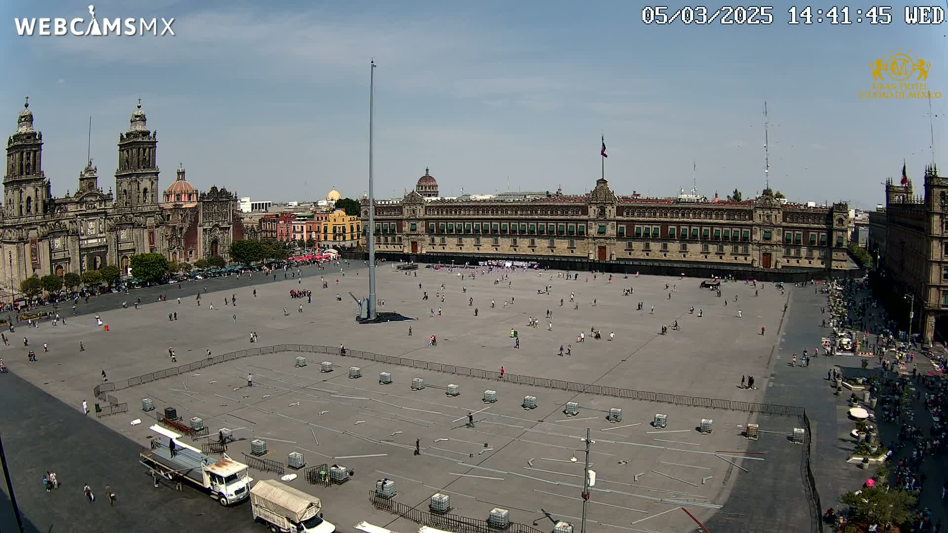 A large plaza with a cathedral and government building in the background, under sunny skies.