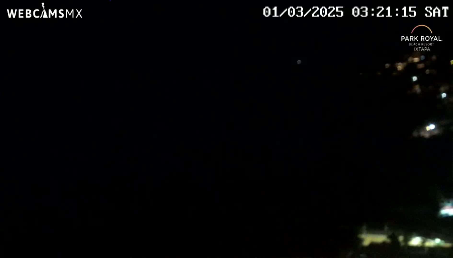 A nighttime long shot shows a blurry view of distant lights in the darkness.