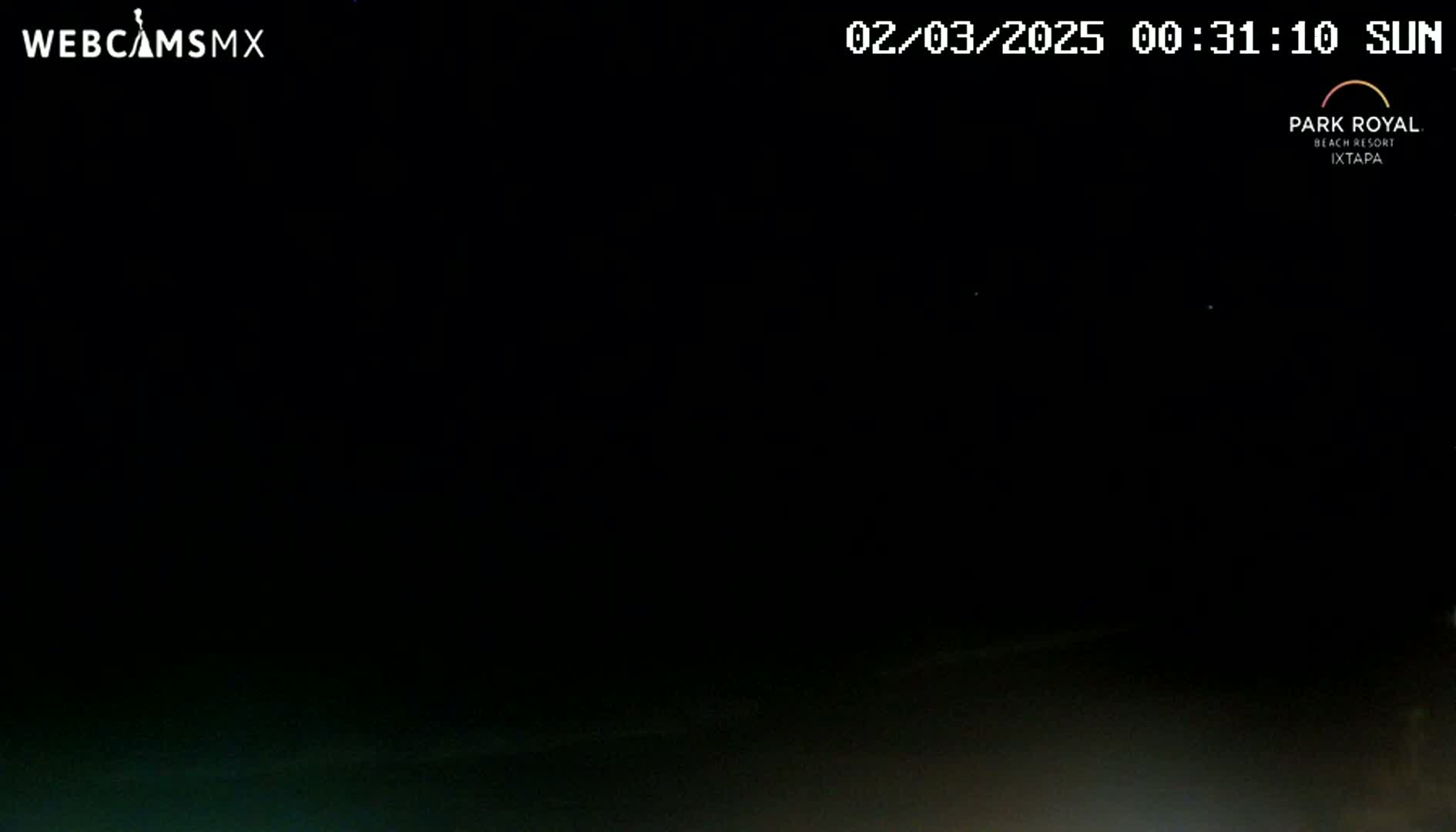 A nighttime outdoor scene shows a dark sky with a very faint, dark-colored horizon.