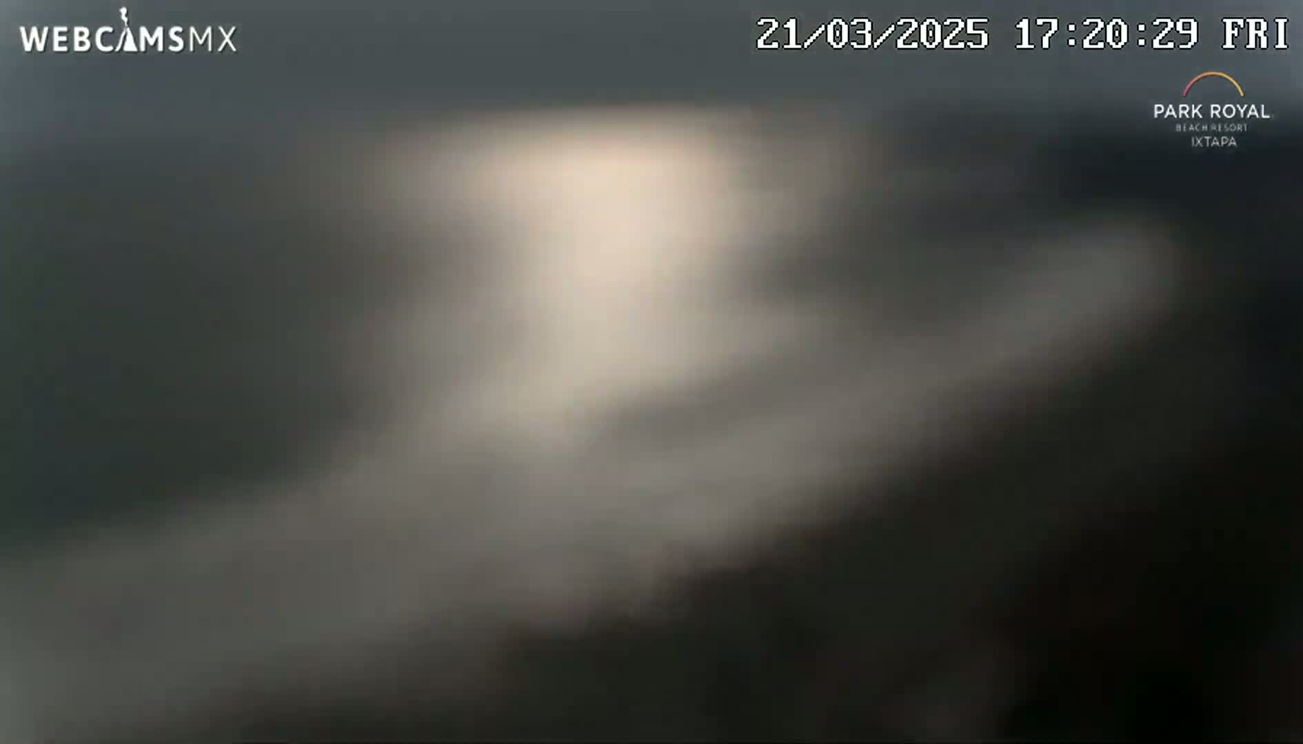 A blurry, dark image shows an overcast sky.