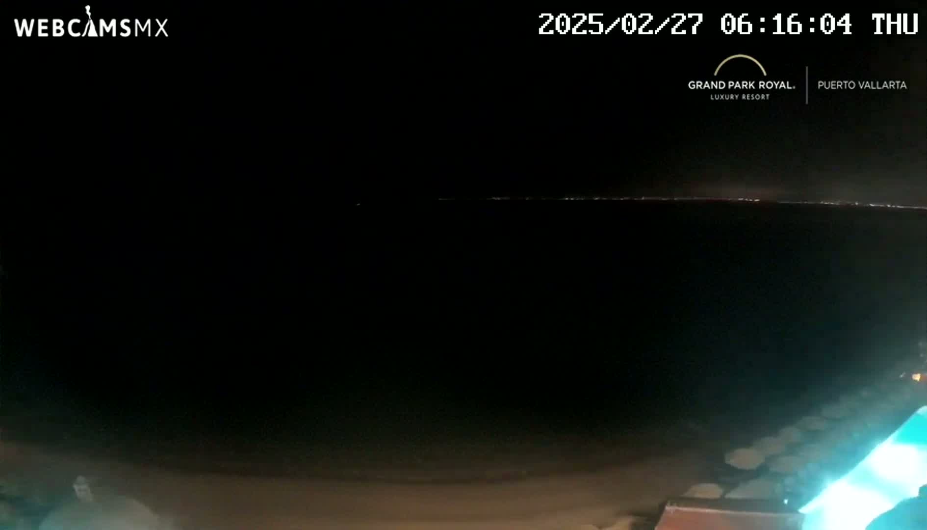 A dark, nighttime scene shows a dimly lit horizon line with a pool of illuminated water in the bottom right corner.