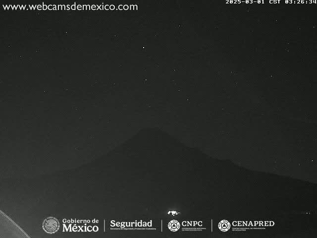 A dark, nighttime view shows a mountain silhouette under a clear, starry sky.