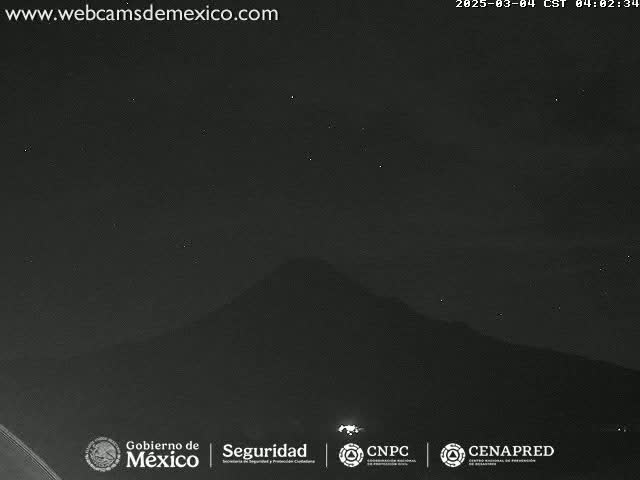 A dark, nighttime scene shows a mountain silhouetted against a sparsely starlit sky.
