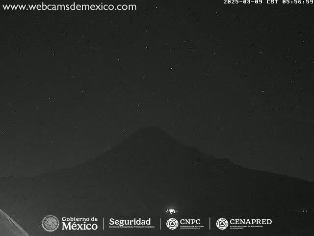 A nighttime long shot shows a dark mountain silhouetted against a clear, starry sky.