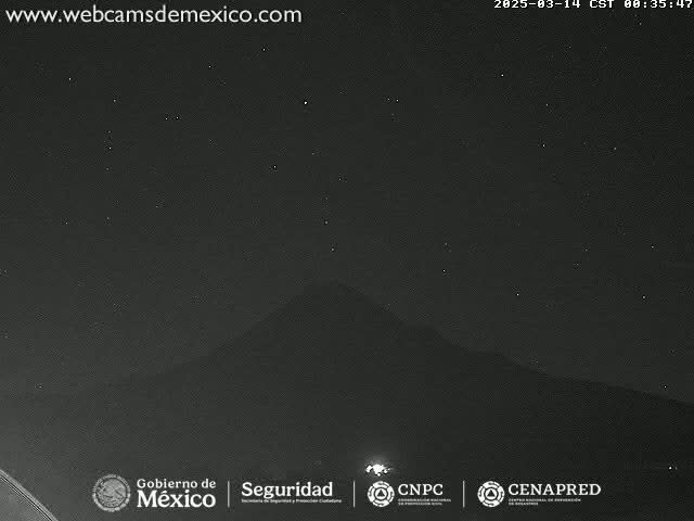 A nighttime, long shot shows a dark mountain silhouetted against a starry sky.