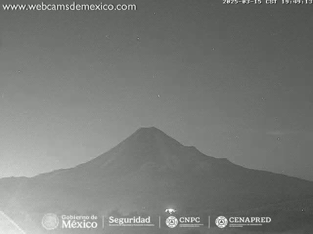 A large, dark mountain is visible under a night sky with a few stars.