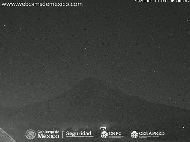 A dark, starlit night shows a silhouetted mountain in the distance.
