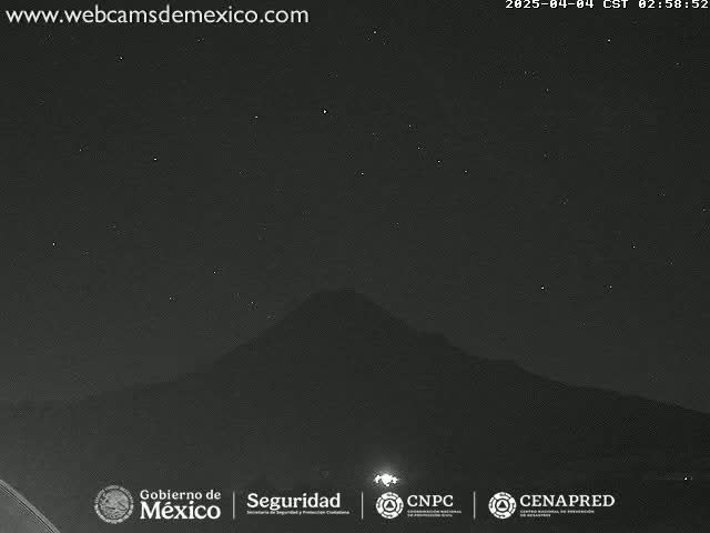 A nighttime long shot shows a dark mountain silhouetted against a clear, starry sky.