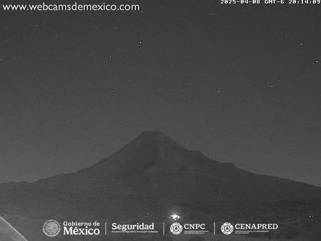 A dark, nighttime view of a large volcano under a clear, starry sky.