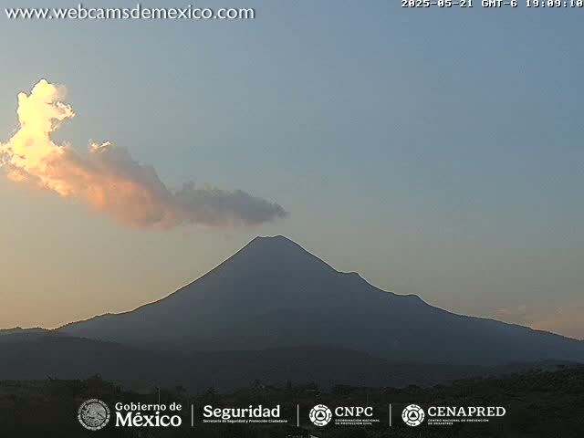 A large, dark volcano is visible under a mostly clear sky with a single, pale pink and white cloud.