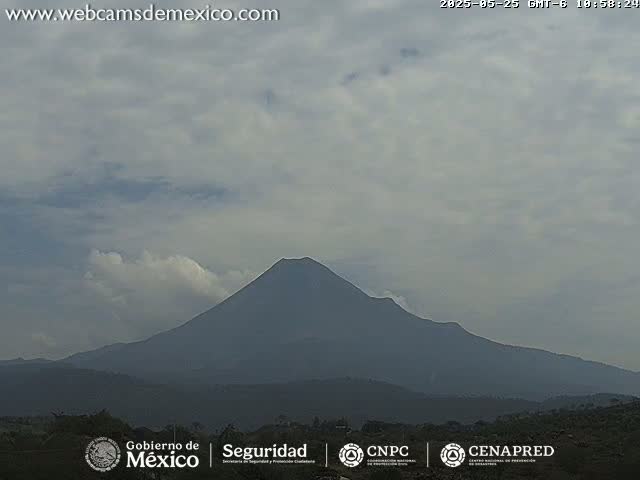 A large, dark volcano is visible under a mostly cloudy sky.