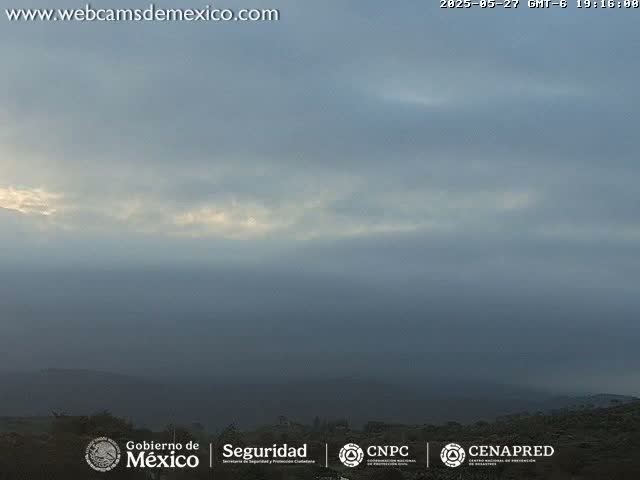 A hazy, overcast sky hangs over a distant, dark landscape.