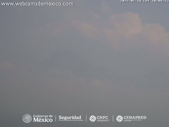 A mostly cloudy, hazy sky is visible.