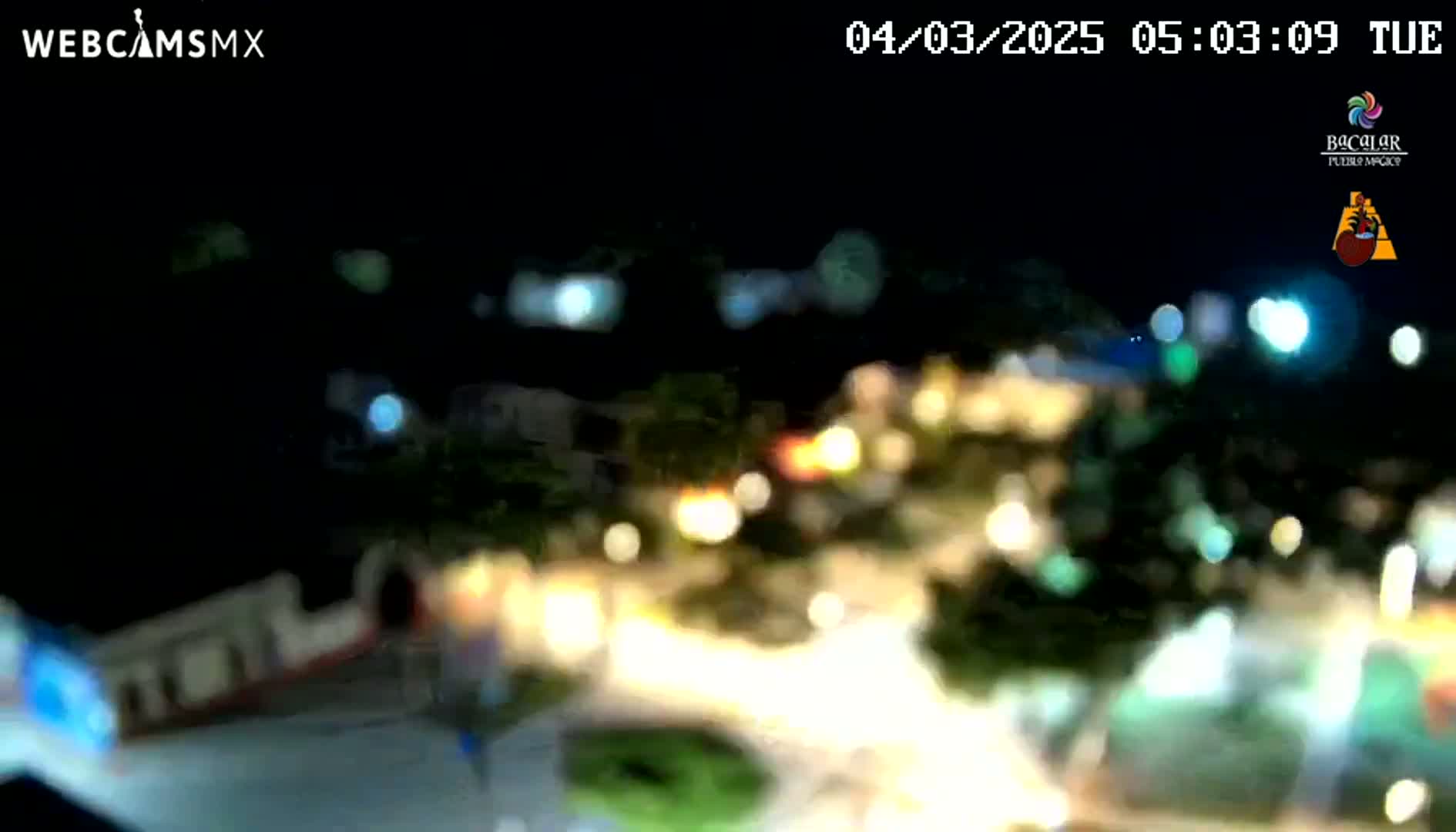 A blurry nighttime view of a town or city with many lights visible.