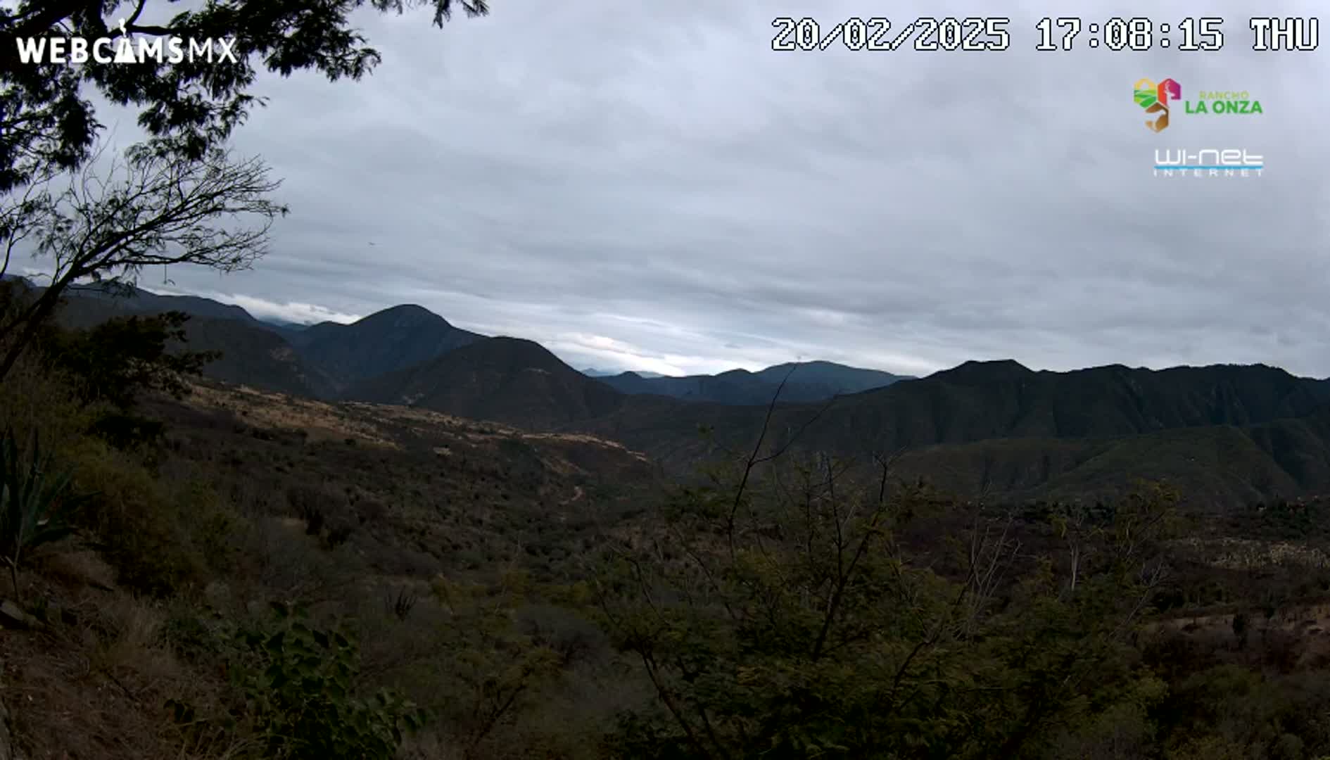 A view of a mountainous landscape under an overcast sky.