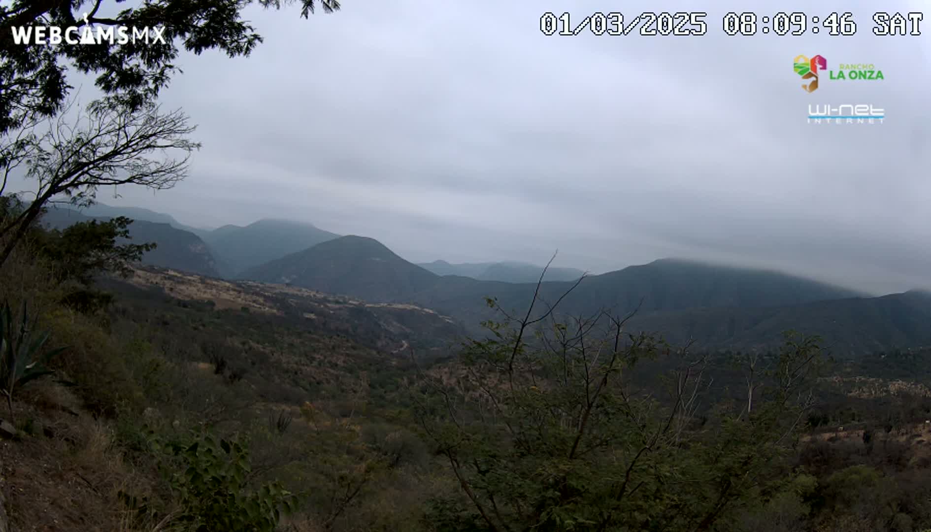A view of a mountainous landscape under an overcast sky.