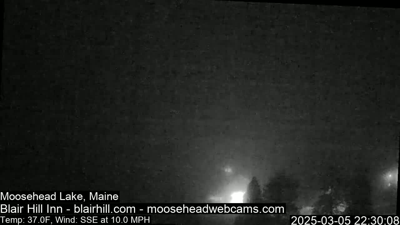 A nighttime, low-visibility outdoor scene shows a dark sky with faint lights in the distance, under conditions of 37°F and a 10 mph SSE wind.