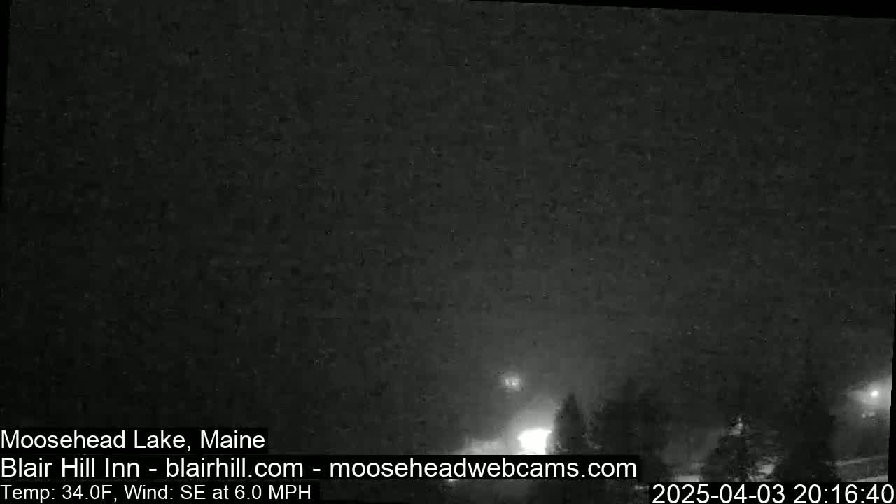 A nighttime, hazy, outdoor scene with a few distant lights visible.
