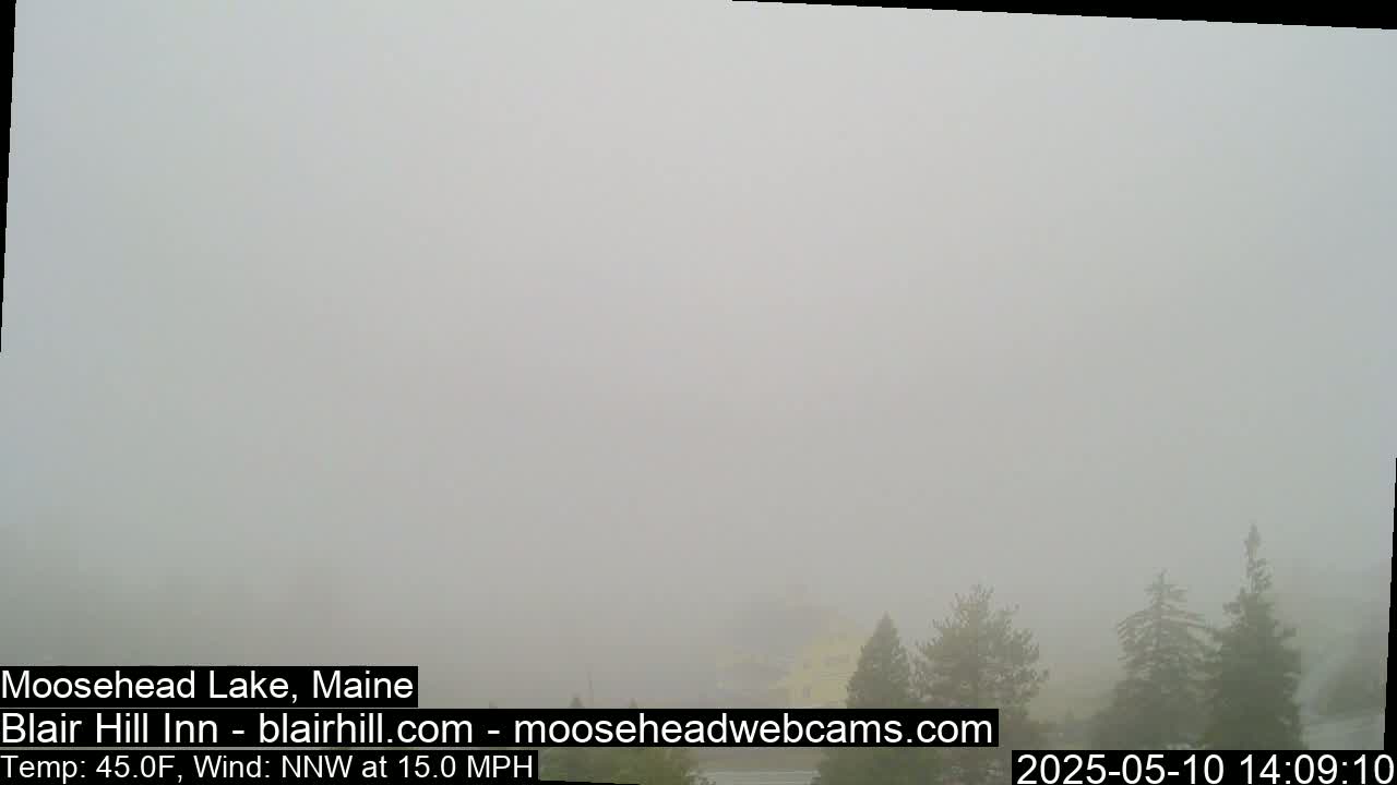 A foggy landscape shows a few evergreens in the distance, with a northwest wind blowing at 15 mph and a temperature of 45°F.