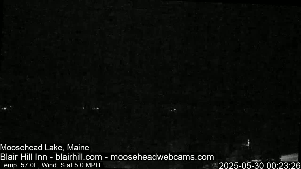 A nighttime, outdoor scene shows a dark landscape under a clear sky with a 5 mph south wind and a temperature of 57°F.