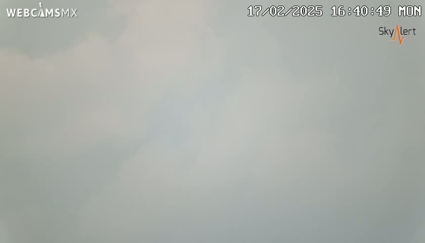 A mostly cloudy, overcast sky is visible.