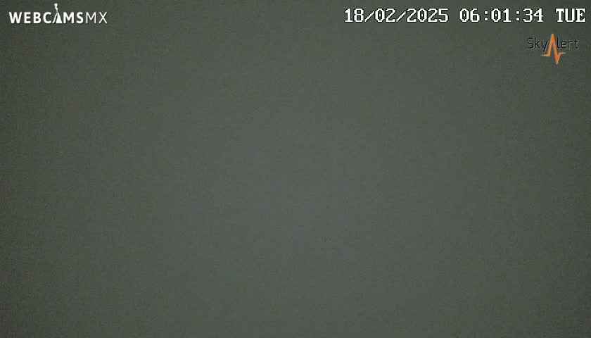 A dark gray, overcast sky is visible.
