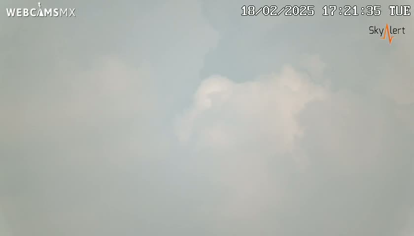 A mostly cloudy, overcast sky is visible.
