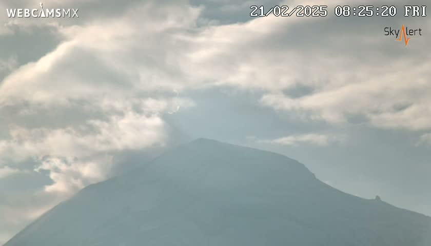 A mostly cloudy sky partially obscures a large, dark mountain.