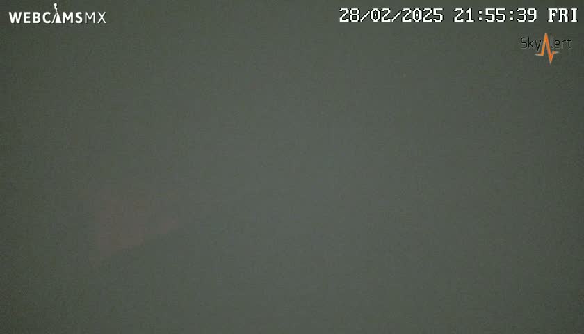 A dark gray, overcast sky is visible at night.
