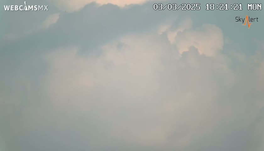 A mostly cloudy sky is visible.