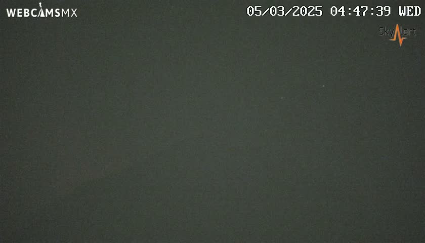 A dark, uniformly colored image shows a mostly clear night sky.