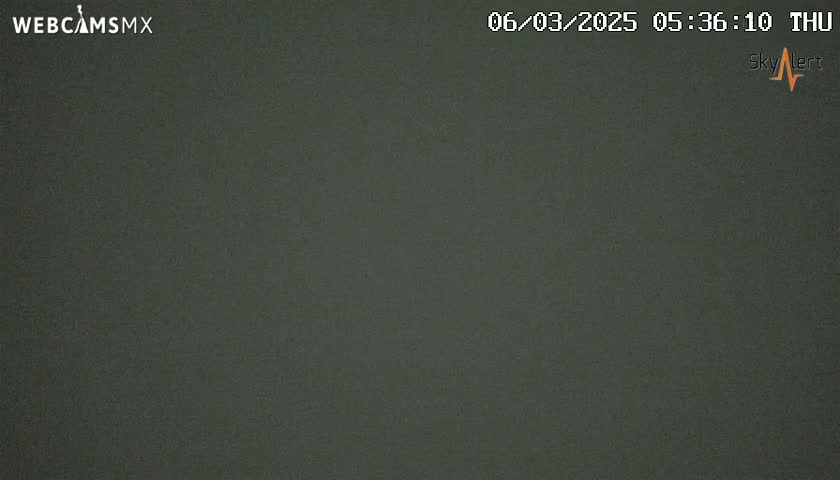 A dark gray, overcast sky is visible.