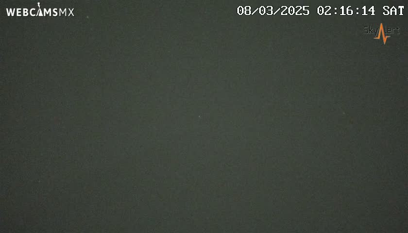 A dark, uniformly colored image shows a night-time scene with an overcast sky.