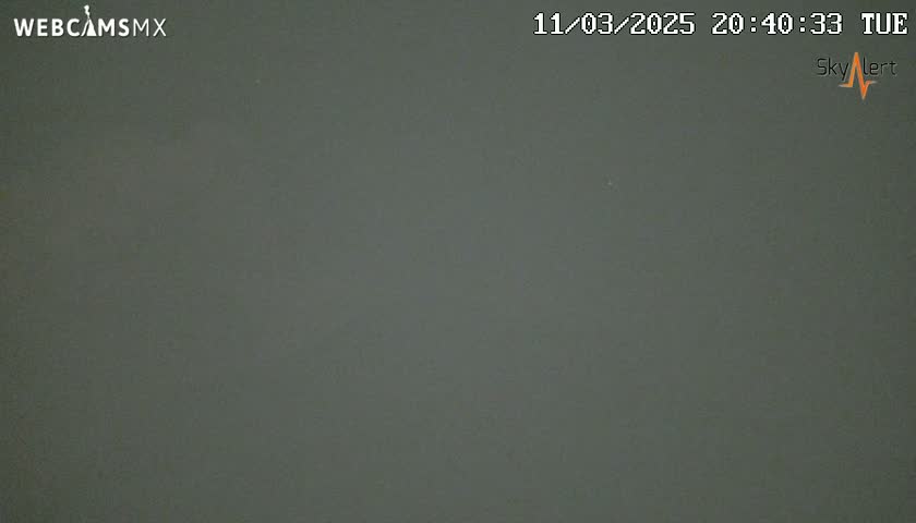 A dark gray, overcast sky is visible at night.