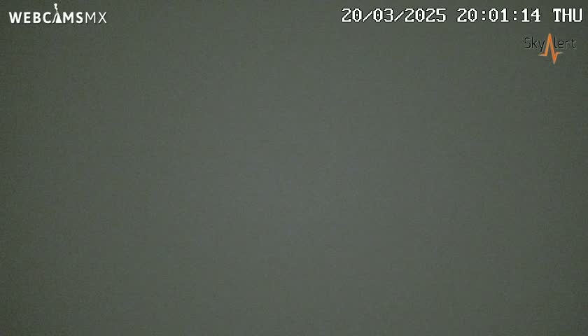 A dark gray, uniformly colored image shows an overcast sky at night.