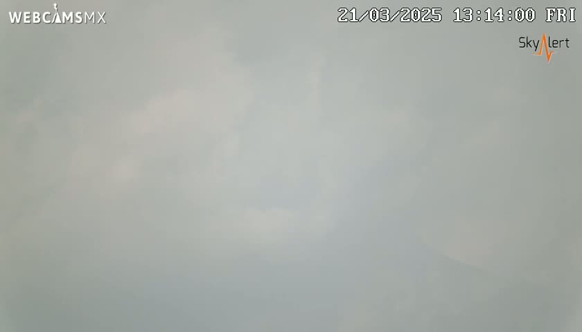 A mostly overcast sky is visible, with a few faint patches of brighter sky showing through.