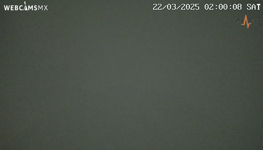 A dark gray, uniformly colored image shows an overcast sky at night.