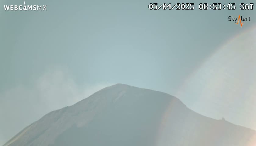 A hazy, light-grey sky obscures a distant mountain peak.