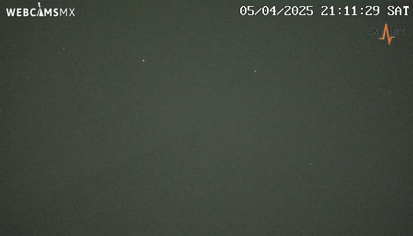 A dark-grey nighttime sky shows three faint lights.