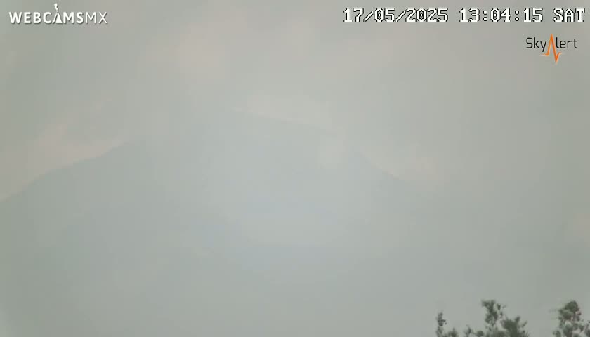 A hazy, gray day reveals a distant mountain range partially obscured by fog or smoke.
