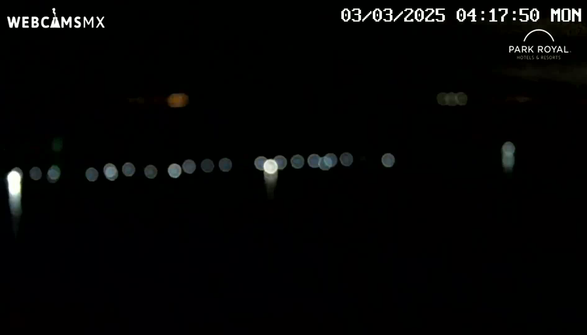 A nighttime, long-distance view of blurred lights in the distance.