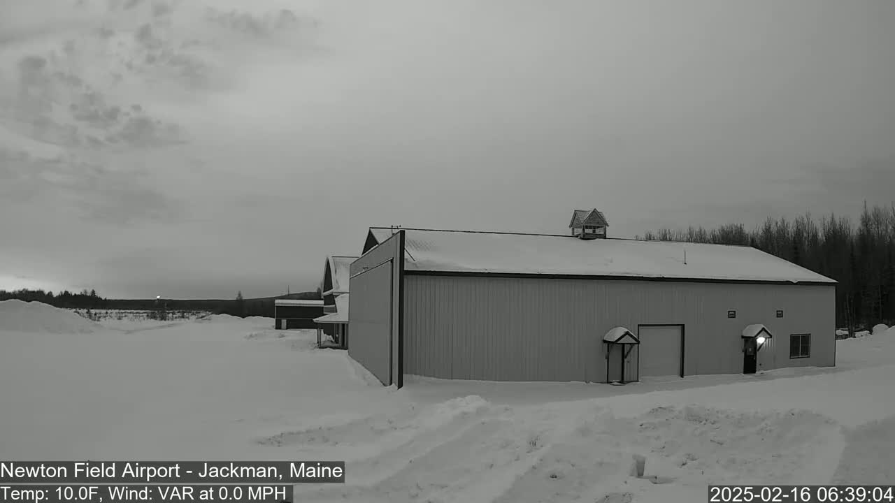 A large, snow-covered building stands in a snowy landscape under an overcast sky.