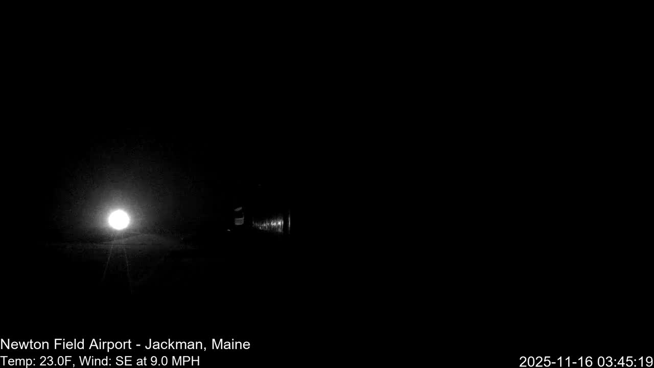 A clear night reveals a bright circular light source illuminating a small foreground area, with a dark, cylindrical object barely visible to its right.