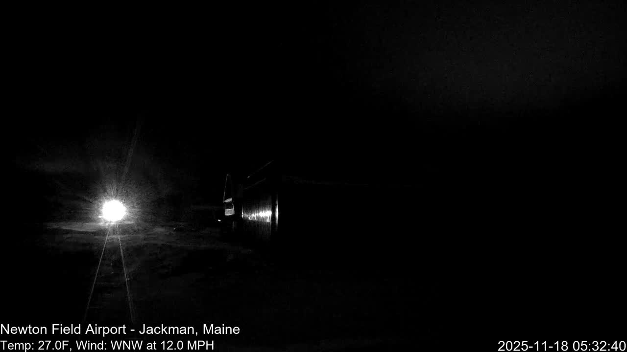 A clear night reveals a bright circular light source illuminating a small foreground area, with a dark, cylindrical object barely visible to its right.