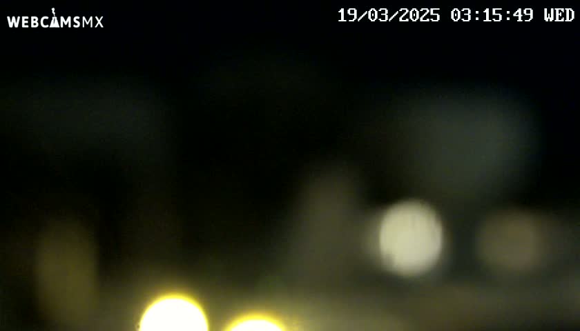 At night, blurry, out-of-focus lights are visible in the dark.