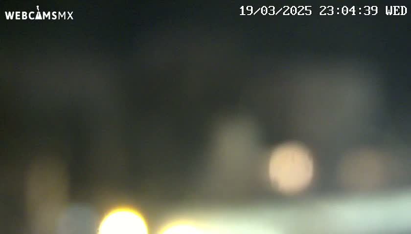 Blurry out-of-focus nighttime image showing indistinct lights.