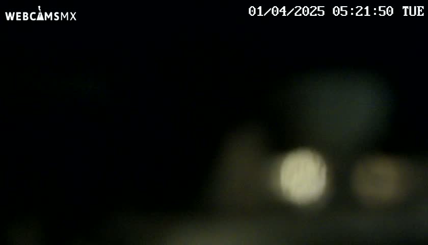 A blurry, dark image shows out-of-focus lights at night.