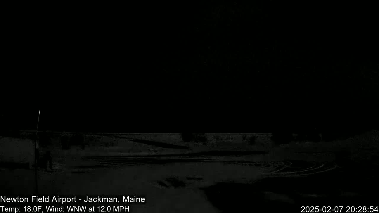 A dark, snowy nighttime scene with a 12 mph wind from the west-northwest and a temperature of 18 degrees Fahrenheit.